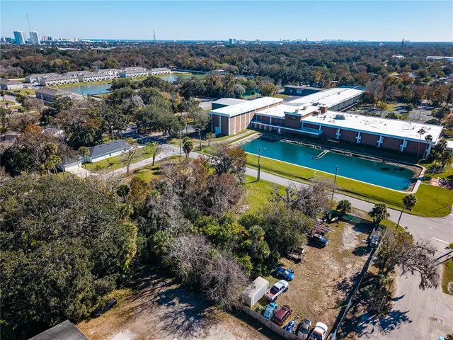 an aerial view of residential houses with outdoor space and river