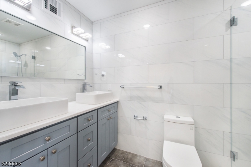 67 Harrison Street Nutley, NJ 07110 - Photo 11 of 20 a bathroom with a toilet sink and mirror