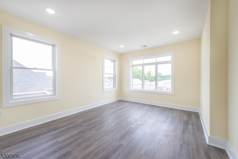 67 Harrison Street Nutley, NJ 07110 - Photo 13 of 20 a view of an empty room with wooden floor and a window