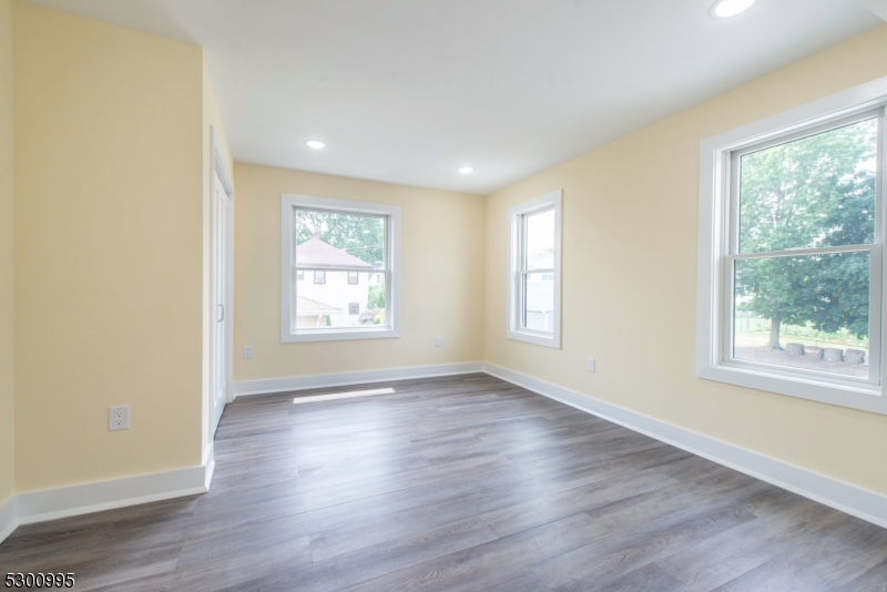 67 Harrison Street Nutley, NJ 07110 - Photo 16 of 20 a view of an empty room with wooden floor and a window