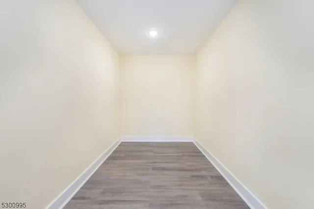 a view of a room with wooden floor