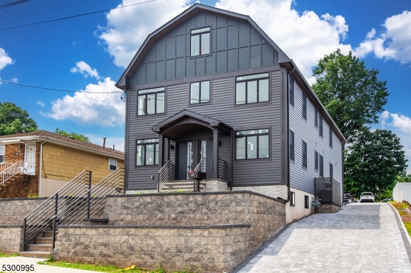 67 Harrison Street Nutley, NJ 07110 - Photo 2 of 20 a front view of a house with garage