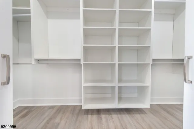 a view of a room with shelf and wooden floor