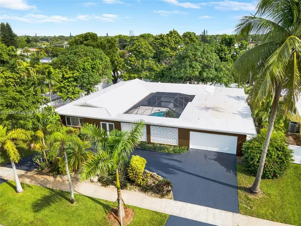 an aerial view of a house with a yard