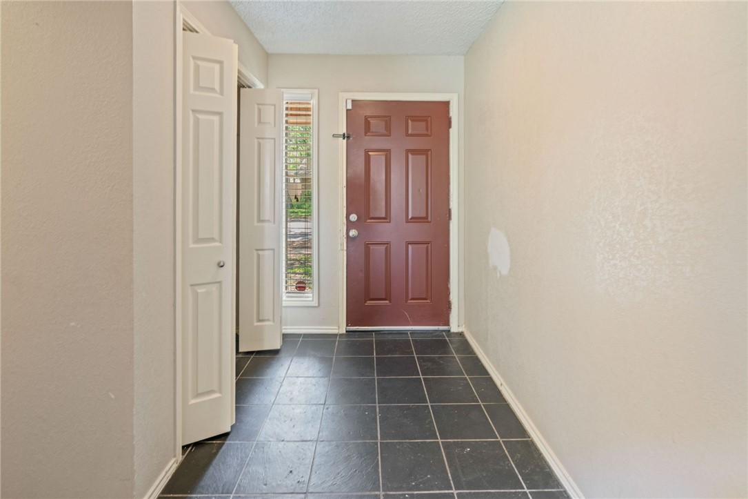 7209 Candy Ridge Road Corpus Christi, TX 78413 - Photo 5 of 24 a view of a hallway with wooden floor and a bathroom