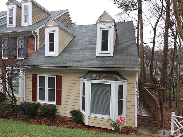 6800 Daltrey Court Raleigh, NC 27613 - Photo 1 of 12 a front view of a house with a yard and garage