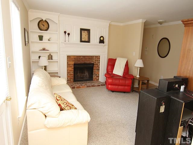 6800 Daltrey Court Raleigh, NC 27613 - Photo 3 of 12 a living room with furniture and a fireplace