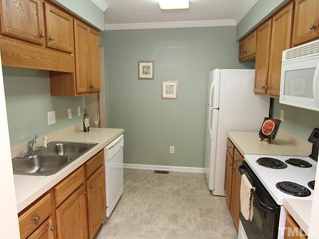6800 Daltrey Court Raleigh, NC 27613 - Photo 6 of 12 a kitchen with a sink a stove and refrigerator