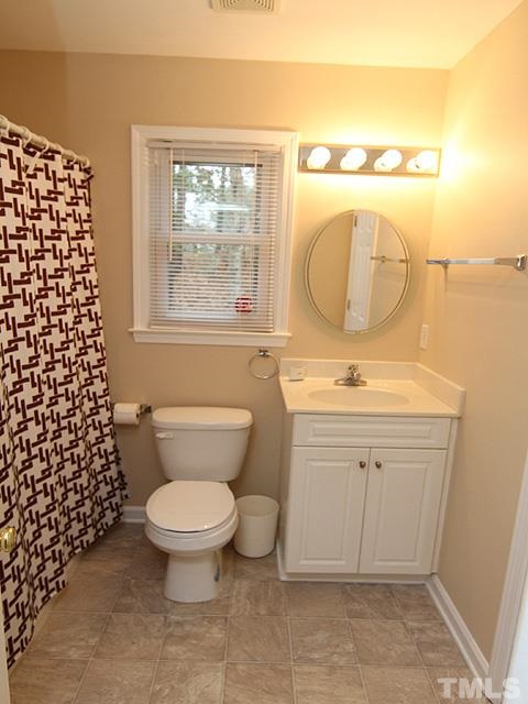6800 Daltrey Court Raleigh, NC 27613 - Photo 10 of 12 a bathroom with a sink toilet and shower