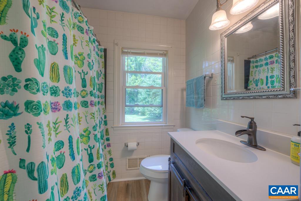 1935 Lambs Road Charlottesville, VA 22901 - Photo 18 of 24 a bathroom with a sink toilet and a mirror
