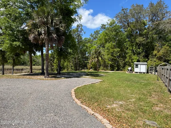 a view of a tree in front of a house
