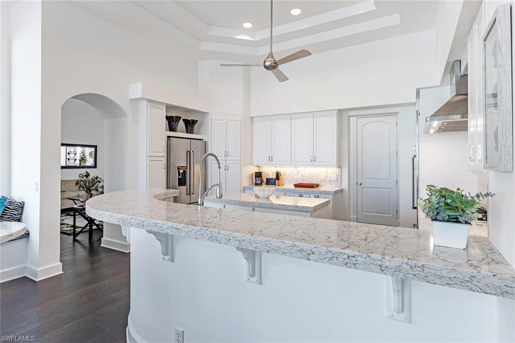 2540 Half Moon Walk Naples, FL 34102 - Photo 11 of 44 a kitchen with kitchen island a counter top space a sink stainless steel appliances and cabinets