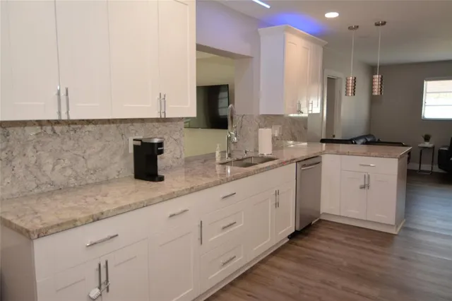 a kitchen with cabinets and stainless steel appliances