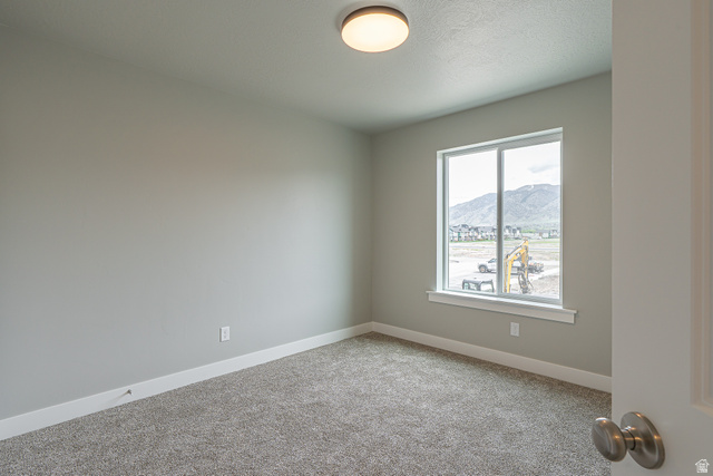 2257 South 1090 West, Unit 74 Nibley, UT 84321 - Photo 11 of 40 Neutral-toned interior room featuring light gray walls, plush carpet flooring, a large window, and white trim
