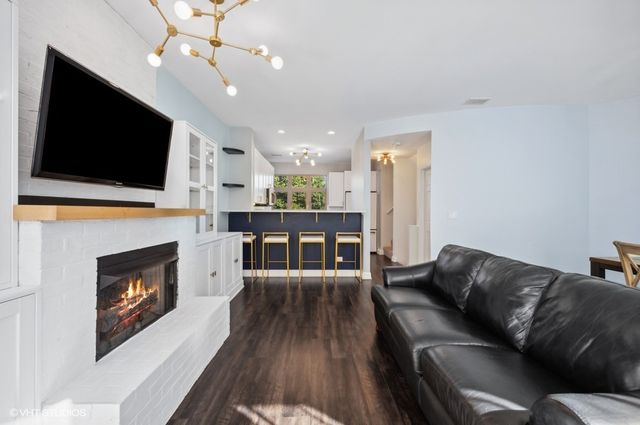 a living room with furniture fireplace and flat screen tv