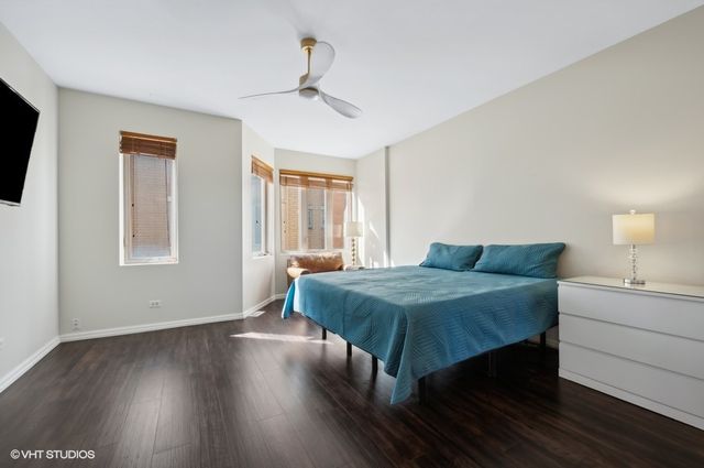 a living room with a bed furniture and a flat screen tv