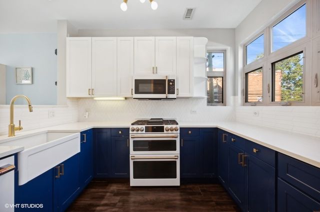 a kitchen with a sink stove and microwave