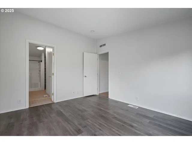 a bathroom with a granite countertop sink toilet a mirror and shower