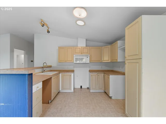 a kitchen with a sink cabinets and window