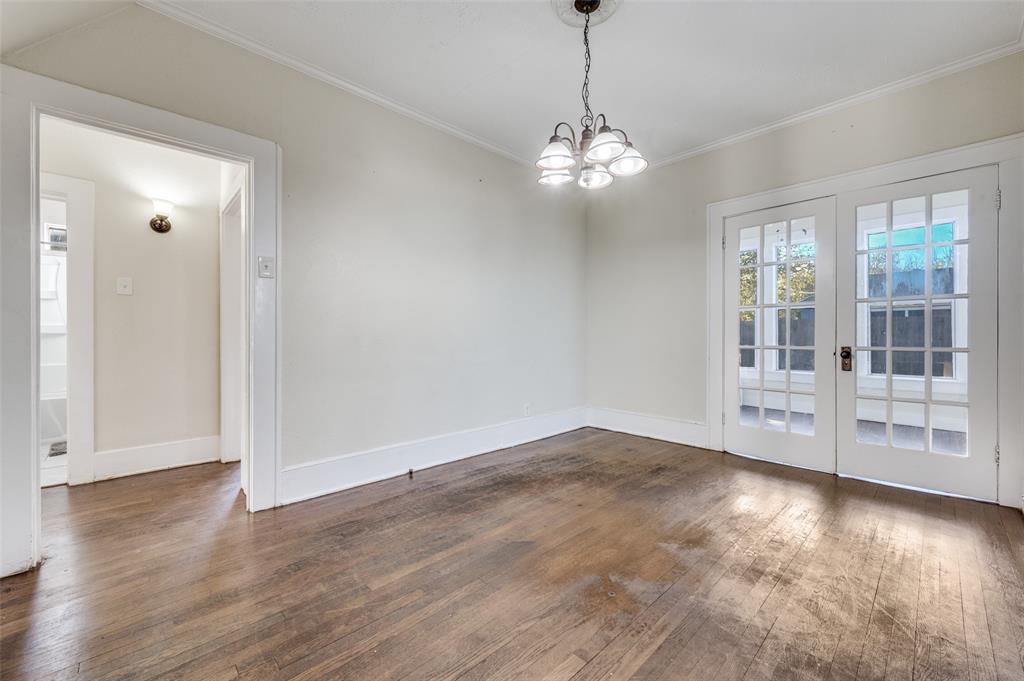 419 North Frances Street Dallas, TX 75211 - Photo 13 of 25 a view of empty room with wooden floor and chandelier