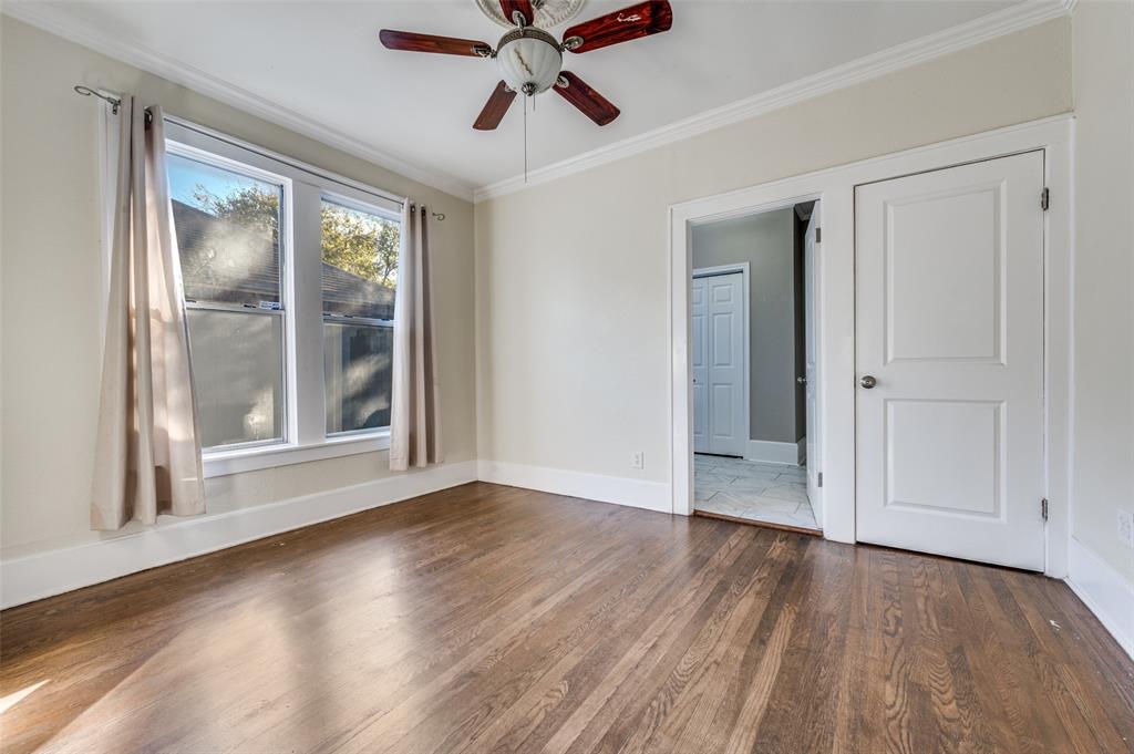 419 North Frances Street Dallas, TX 75211 - Photo 16 of 25 a view of an empty room with wooden floor and a window