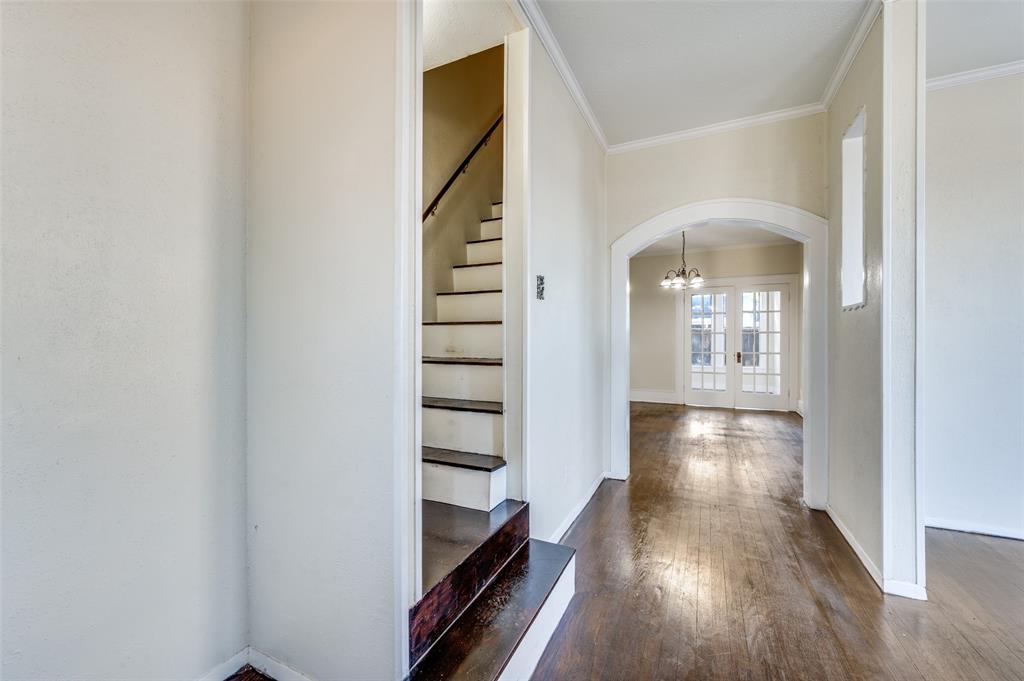 419 North Frances Street Dallas, TX 75211 - Photo 3 of 25 a view of a hallway with wooden floor and staircase