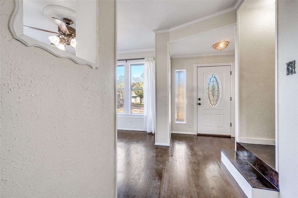 419 North Frances Street Dallas, TX 75211 - Photo 4 of 25 a view of a hallway with wooden floor and staircase