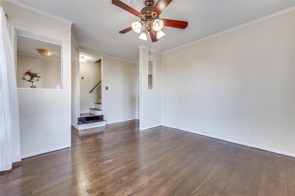 419 North Frances Street Dallas, TX 75211 - Photo 5 of 25 a view of a livingroom with wooden floor and a ceiling fan