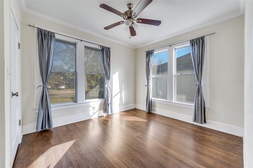 419 North Frances Street Dallas, TX 75211 - Photo 7 of 25 a view of an empty room with a window and wooden floor