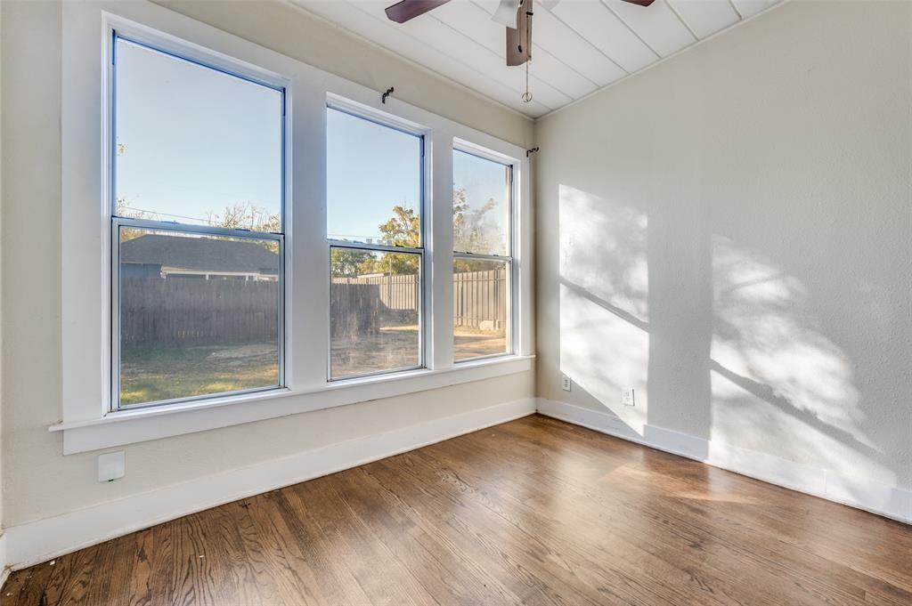 419 North Frances Street Dallas, TX 75211 - Photo 9 of 25 a view of an empty room with a window and wooden floor