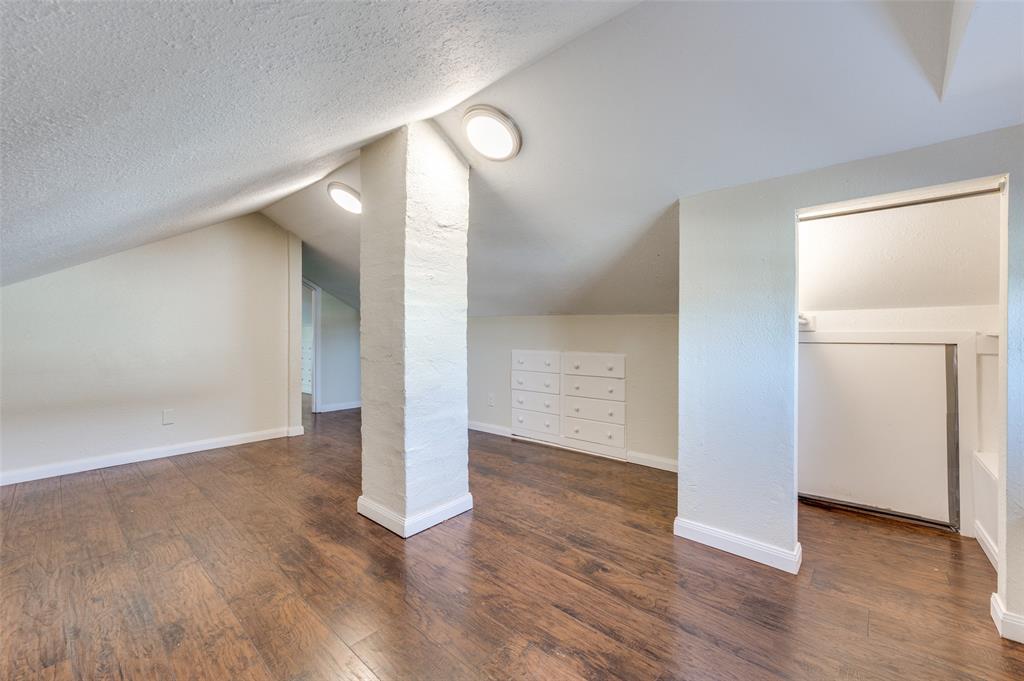 419 North Frances Street Dallas, TX 75211 - Photo 10 of 25 wooden floor in an empty room with a window