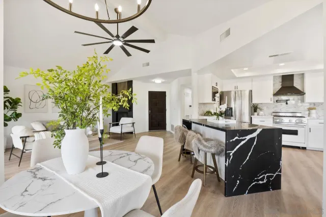a view of a dining room with furniture and a chandelier