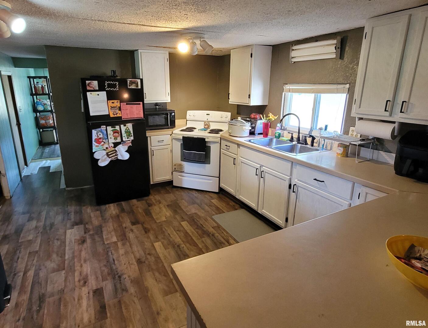 3993 Greenridge Road Alma, IL 62807 - Photo 8 of 45 a kitchen with stainless steel appliances a stove top oven a sink dishwasher and a dining table with wooden floor