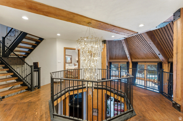 2687 Stewart Road Sundance, UT 84604 - Photo 27 of 48 Staircase with suspended lighting, beamed ceiling, and wood-type flooring