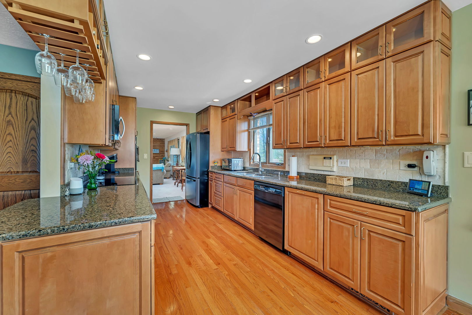 108 Deerpath Drive Minooka, IL 60447 - Photo 12 of 45 a kitchen with granite countertop lots of counter top space and wooden floor