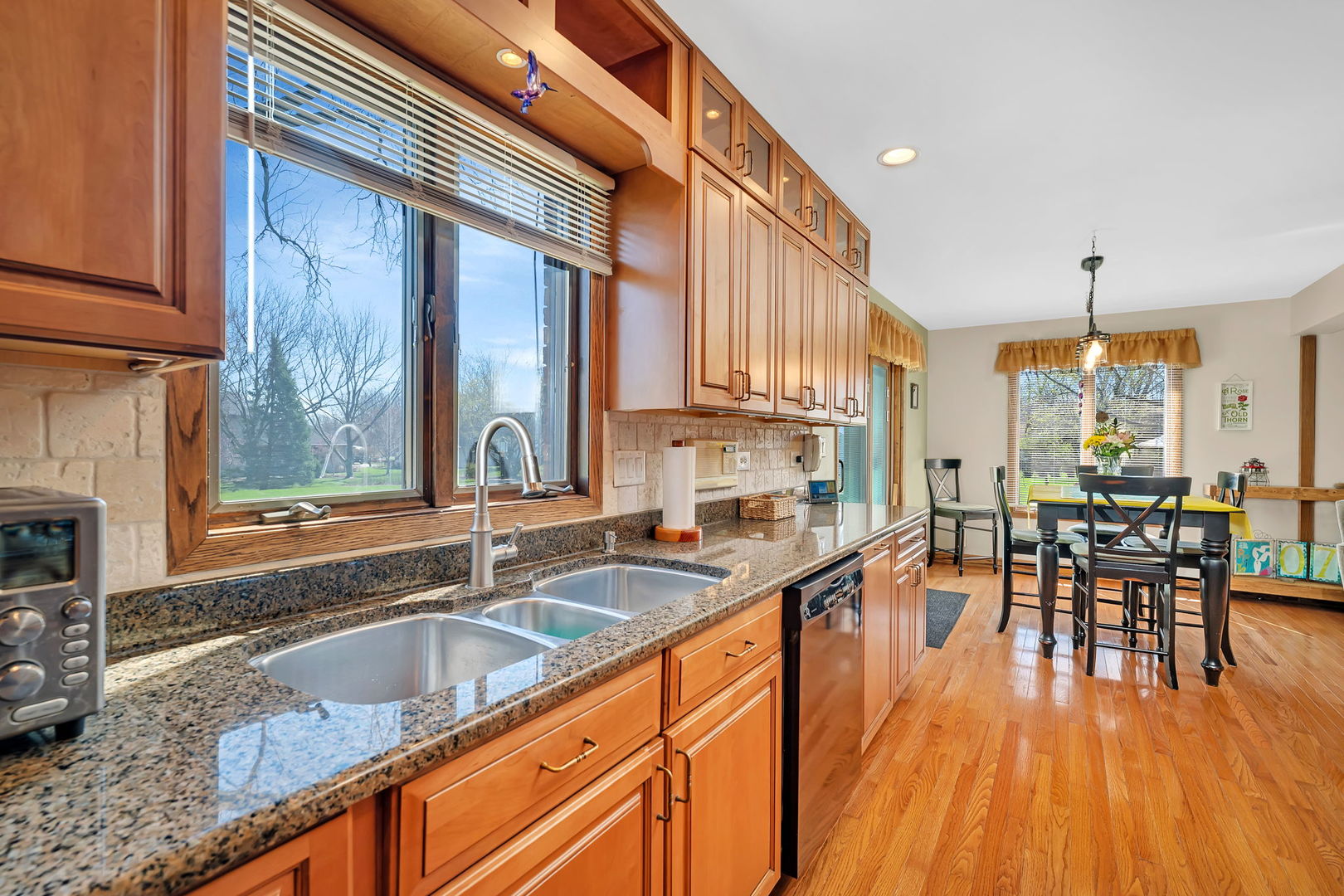 108 Deerpath Drive Minooka, IL 60447 - Photo 13 of 45 a kitchen with granite countertop a sink a counter top space and stainless steel appliances