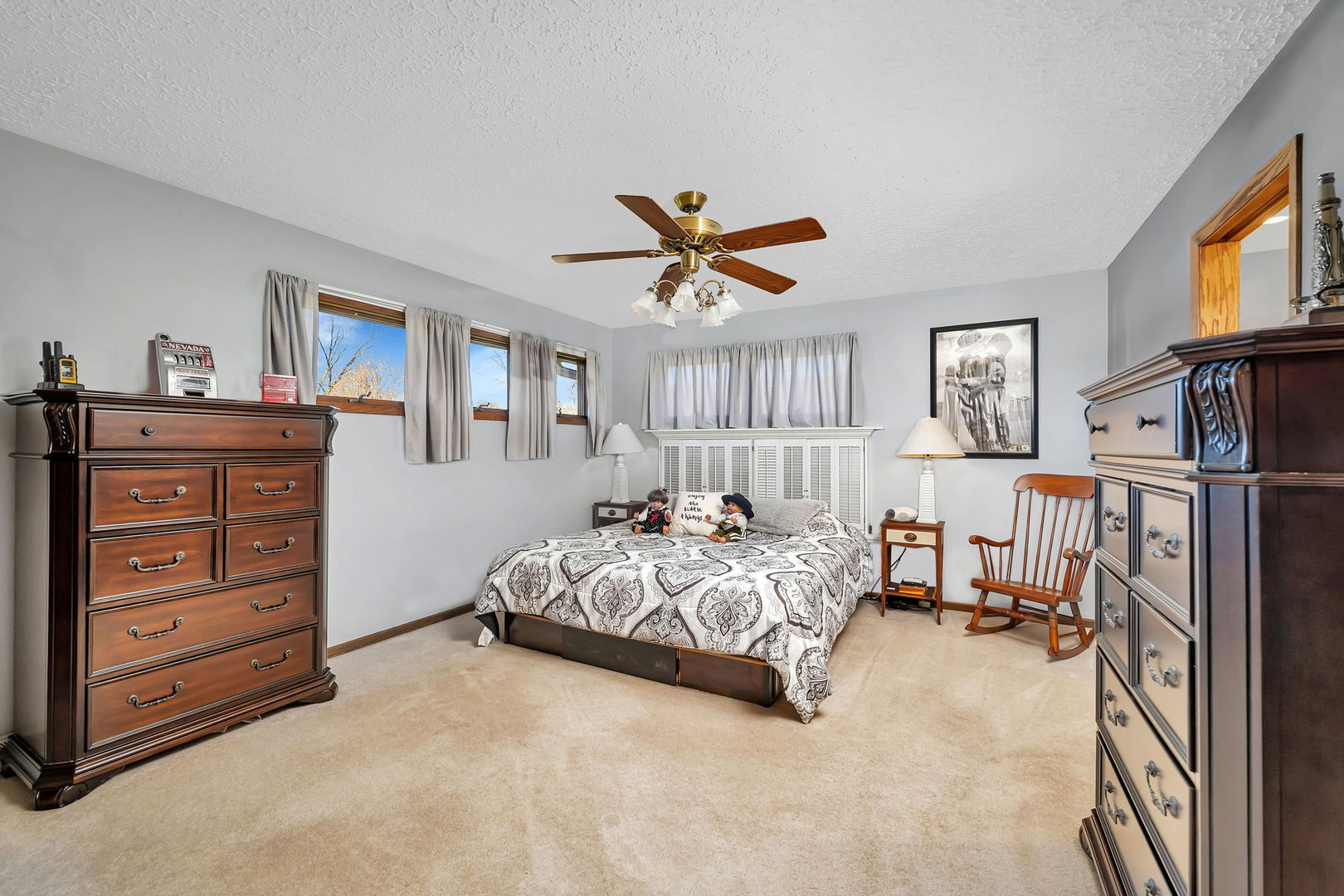 108 Deerpath Drive Minooka, IL 60447 - Photo 17 of 45 a bedroom with a bed and a chandelier