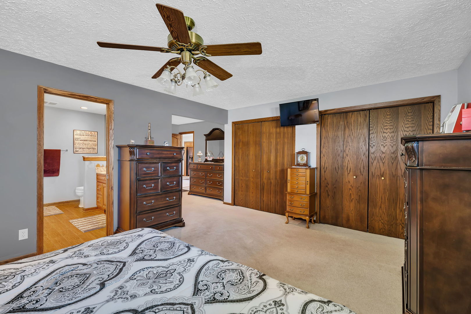 108 Deerpath Drive Minooka, IL 60447 - Photo 18 of 45 a bedroom with a dresser and a chandelier