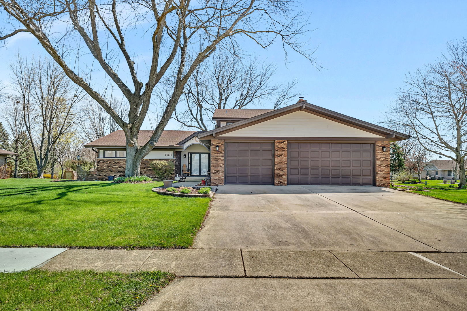 108 Deerpath Drive Minooka, IL 60447 - Photo 2 of 45 a front view of a house with a garden and trees