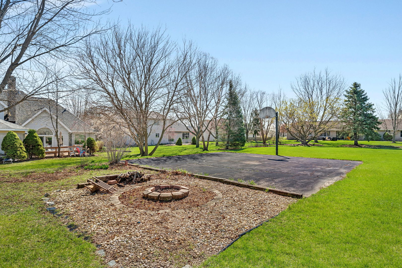 108 Deerpath Drive Minooka, IL 60447 - Photo 36 of 45 a view of a fire pit with large trees