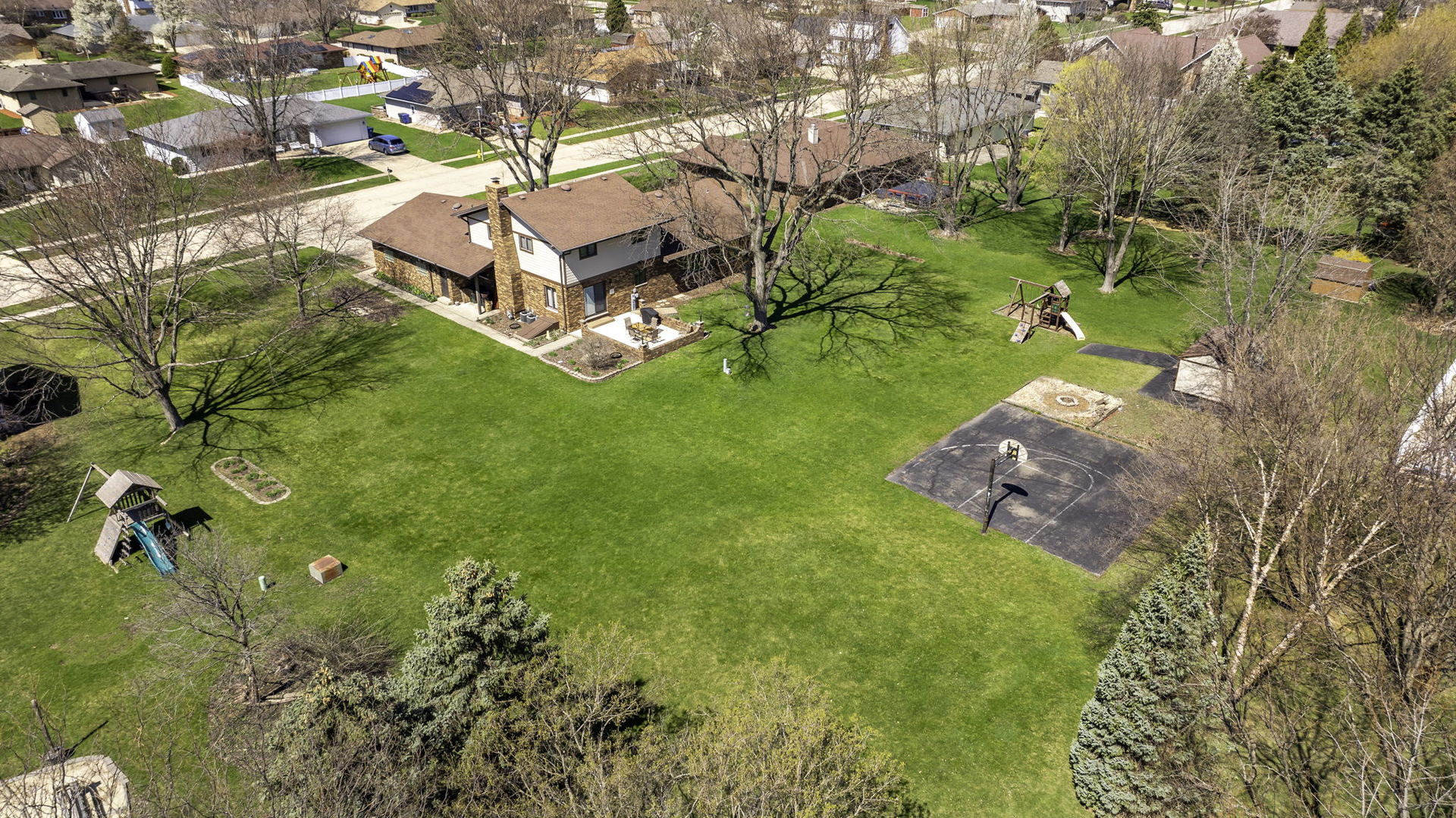 108 Deerpath Drive Minooka, IL 60447 - Photo 40 of 45 an aerial view of a house with garden space and trees all around