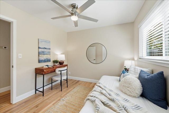 a bedroom with a bed window and a table
