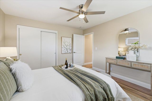 a bedroom with a large bed and a chandelier
