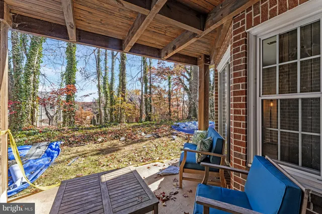 a view of a patio with table and chairs and wooden floor