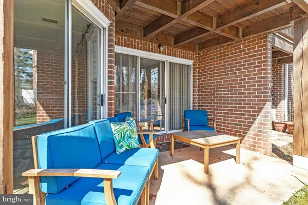 a view of a chairs and table in the back yard of the house