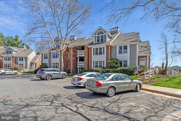 a car parked in front of a brick house