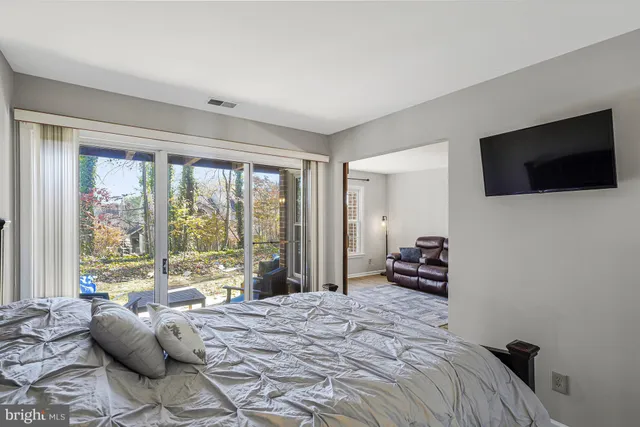 a bedroom with a bed and a television