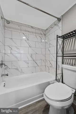 a bathroom with a toilet and a bathtub