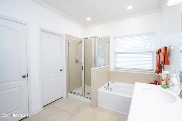 a bathroom with a tub sink and mirror