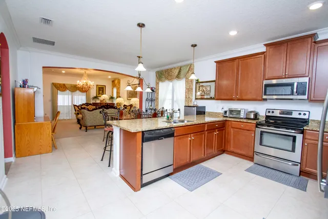 a kitchen with stainless steel appliances granite countertop a stove and a sink